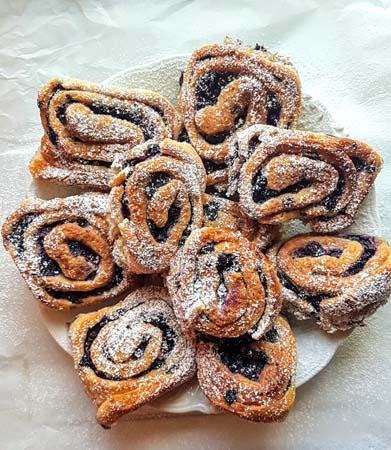 kanelbulle z jagodami i cukrem pudrem